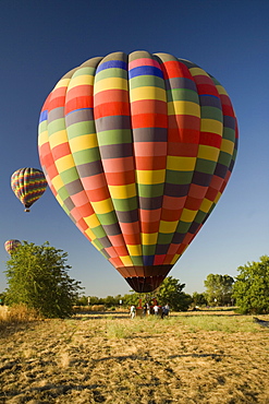 Group of people standing near a hot air balloon