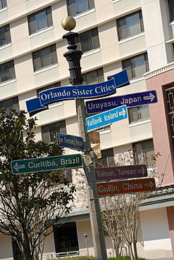 Directional sign in front of a building, Lake Eola Park, Orlando, Florida, USA