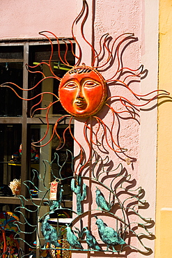 Sun sculpture on a wall, St. Augustine, Florida, USA