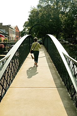 Rear view of a woman walking on a footbridge, Savannah, Georgia, USA