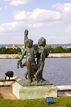 Statues near a pond in a formal garden, Palace of Versailles, Versailles, France