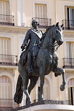 Statue of Carlos III in front of a building, Puerto De Sol, Madrid, Spain