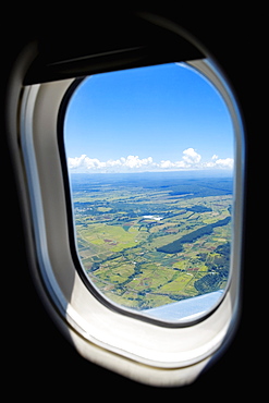 Aerial view of a landscape viewed through an airplane window