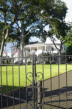 Close-up of a wrought iron gate with a building in the background, Honolulu, Oahu, Hawaii Islands, USA