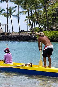 Rear view of a man and a woman canoeing in the sea, Captain Cook's Monument, Kealakekua Bay, Kona Coast, Big Island, Hawaii islands, USA