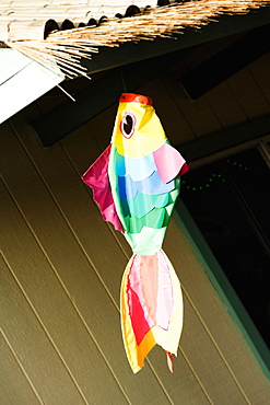 Artificial fish hanging with a thatched roof