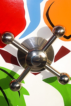 Close-up of a knob on a multi-colored wall