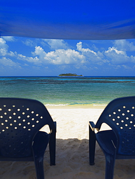 Empty chairs under the tent on the beach, Spratt Bight Beach, San Andres, Providencia y Santa Catalina, San Andres y Providencia Department, Colombia