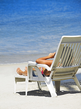 Rear view of a woman lying on a lounge chair on the beach, South West Bay, Providencia, Providencia y Santa Catalina, San Andres y Providencia Department, Colombia