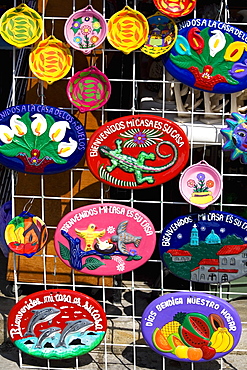 Ceramics hanging on a chain-linked fence, Cancun, Mexico