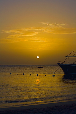 Yacht in the sea at sunset, West Bay Beach, Roatan, Bay Islands, Honduras
