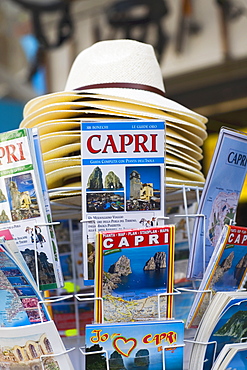 Magazines and sun hats at a market stall, Capri, Campania, Italy