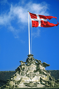 Danish flag fluttering on a sculpture, Amalienborg Palace, Copenhagen, Denmark