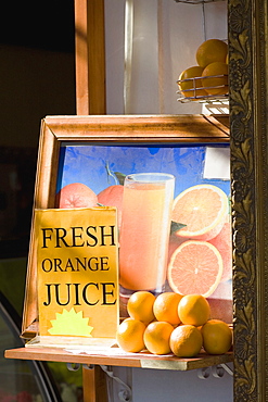 Stack of oranges in front of a photo frame, Rhodes, Dodecanese Islands, Greece