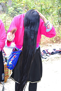 Woman combing her hair, Longsheng, China