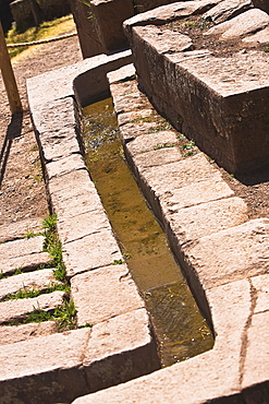 Water flowing through a stone's drain, Pisaq, Urubamba Valley, Peru