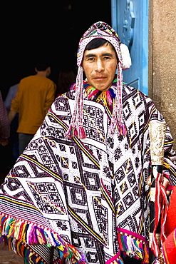 Portrait of a young man wearing a traditional clothing and holding a stick, Peru