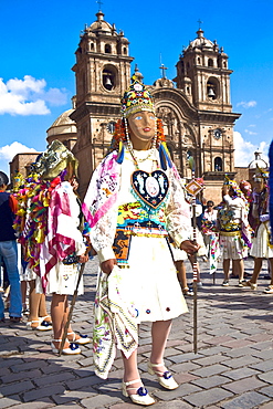 Group of women wearing traditional costumes and standing in front of a church, Peru