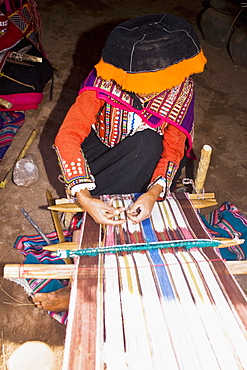 Woman weaving in a loom, Aguanacancha, Peru