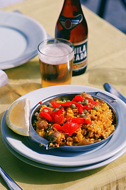 Close-up of paella rice dish with a glass of beer, Granada, Andalusia, Spain