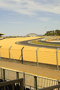 Chain-link fence along with motor racing tracks in a field, Le Mans, France