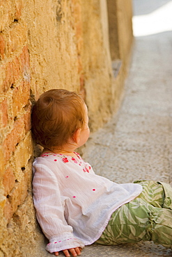 Side profile of a girl leaning against a wall, Monteriggioni, Siena Province, Tuscany, Italy