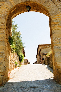 Houses viewed through an archway, Porta Franca, Monteriggioni, Siena Province, Tuscany, Italy