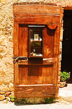 Wooden door of a house, Monteriggioni, Siena Province, Tuscany, Italy