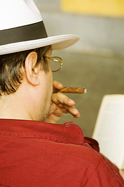 Rear view of a man smoking a cigar, Piazza Colombo, Mercato Orientale, Genoa, Italy