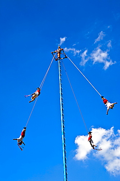 Low angle view of totonac voladores flying dancers flying from the pole, El Tajin, Veracruz, Mexico