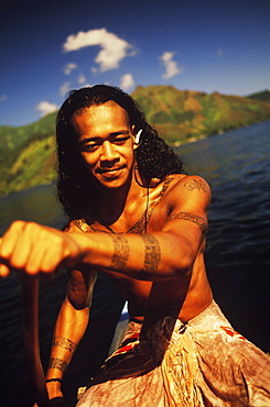 Close-up of a young man rowing a boat, Hawaii, USA