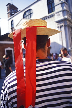 Rear view of a person wearing a straw boater hat, Italy