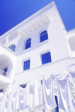 Low angle view of clothes hanging on a clothesline in front of a building