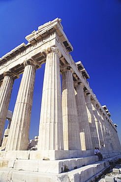 Low angle view of old ruin colonnades in a shrine, Parthenon, Athens, Greece