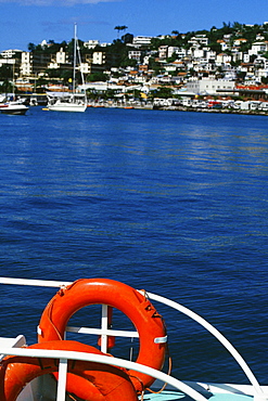 Bright life preservers are seen attached to a railing on a boat in Port de France, Martinique