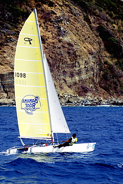 A sailboat participates in the Heiniken Regatta on the Dutch side of the island of St. Maarten in the Caribbean