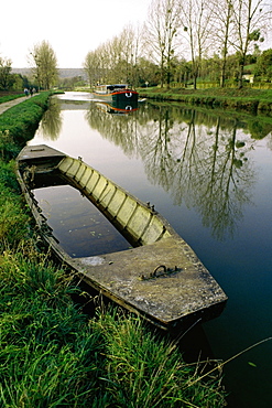 High angle of an old boat with a barge moving upstream, Burgundy Canal, France