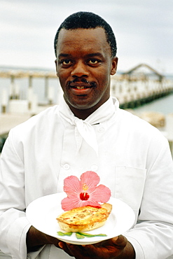 Phillip Bethel holding a garnished dish, Abaco, Bahamas