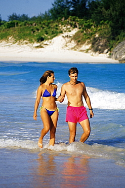 Side view of a couple in swimsuits, Horse-shoe Bay beach, Bermuda