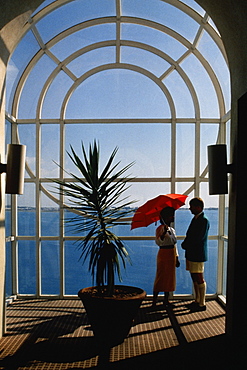 A couple is seen conversing near a plant, Bermuda portfolio, Bermuda