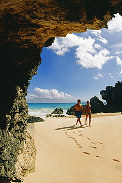 A couple takes a stroll on Horseshoe beach, Bermuda