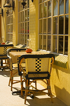 Empty chairs at a sidewalk cafe