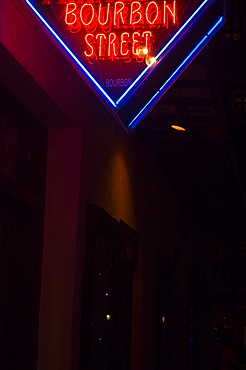 Low angle view of a street name sign lit up at night, New Orleans, Louisiana, USA