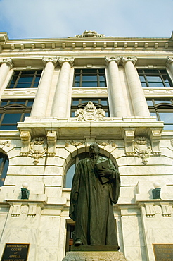 Low angle view of the statue of a judge in front of a courthouse, New Orleans, Louisiana, USA