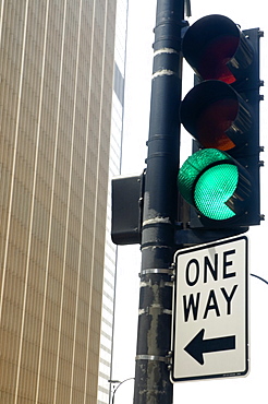 Low angle view of a directional sign on a traffic light, Chicago, Illinois, USA