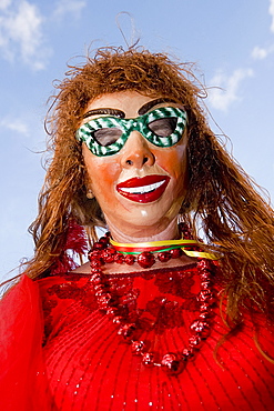 Low angle view of a woman wearing a carnival mask