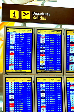 Flight information on an airport display board, Madrid, Spain