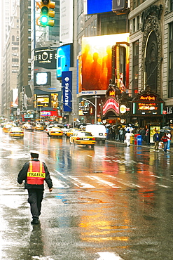 Rear view of a traffic cop walking on the road