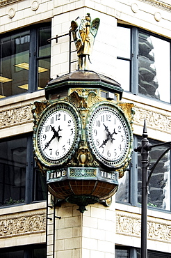 Low angle view of a clock on the side of a building, Chicago, Illinois, USA