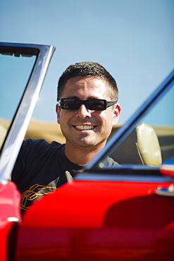 Close-up of a mid adult man sitting in a car